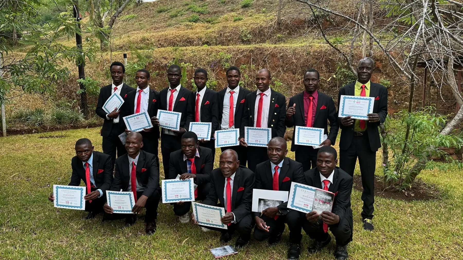 Graduating pastors holding their certificates at the Bible training centre in Malawi