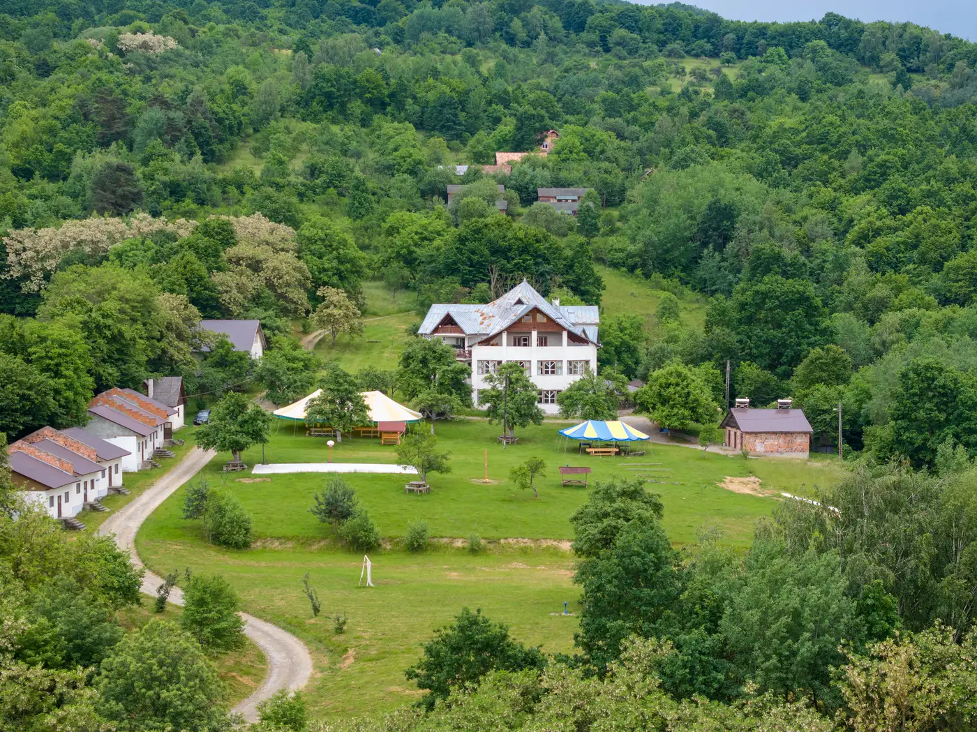 The camp buildings and grounds seen from above, surrounded by forest